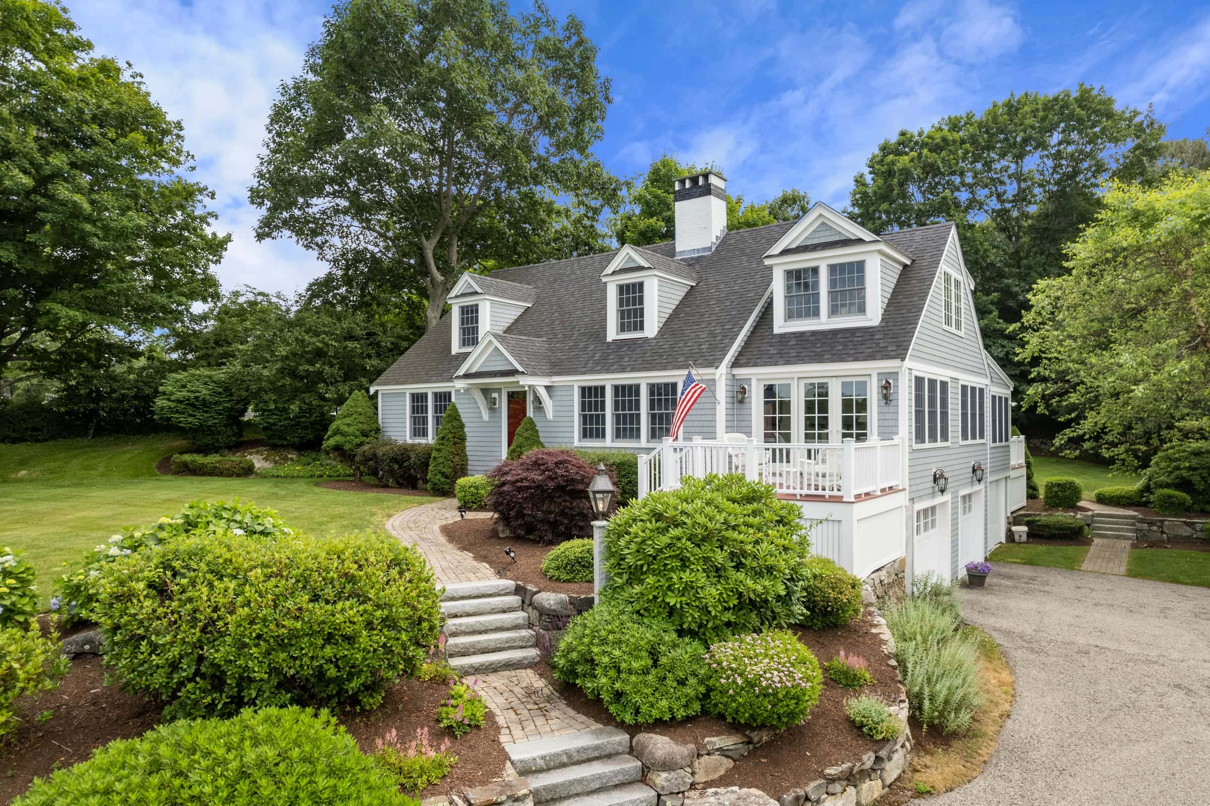 Low-aerial drone photo of a shingle-style coastal cape in New Castle, New Hampshire